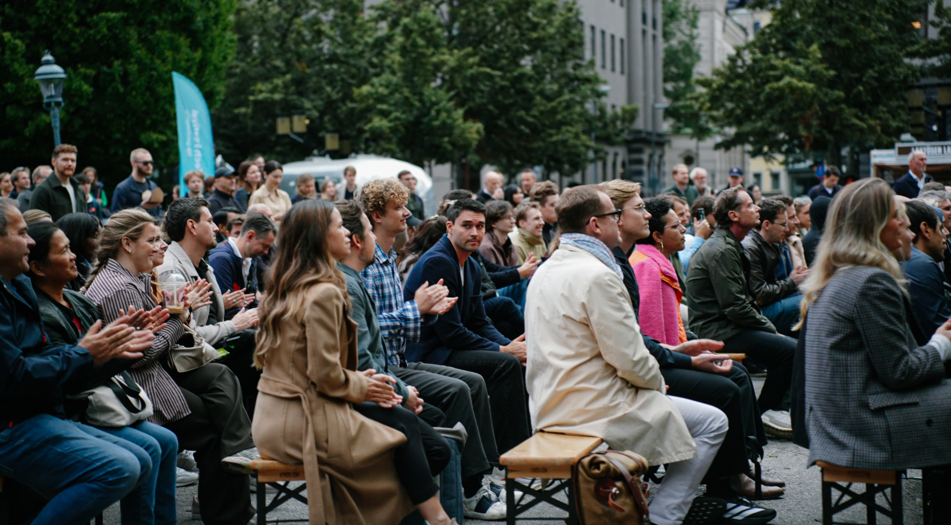 Thousands seated on wooden benches at Tech Open 2025